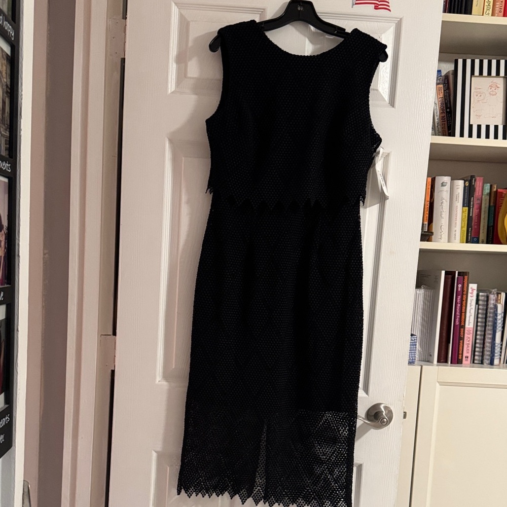 Joseph Ribkoff black sleeveless knit dress with a beaded waist and scoop neck.